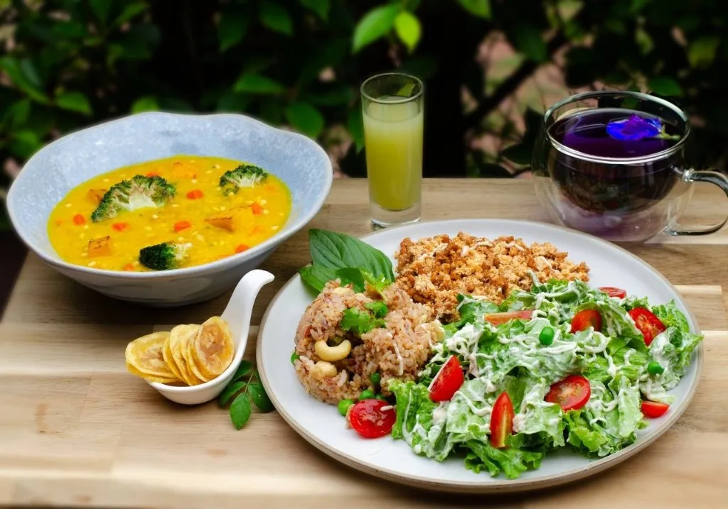 Vegetarian plate with vegetable soup, rice, and salad