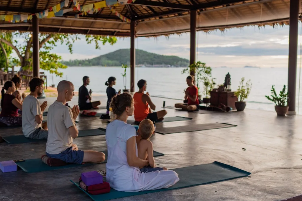 Open-air yoga pavilion on the beach — group session by the sea