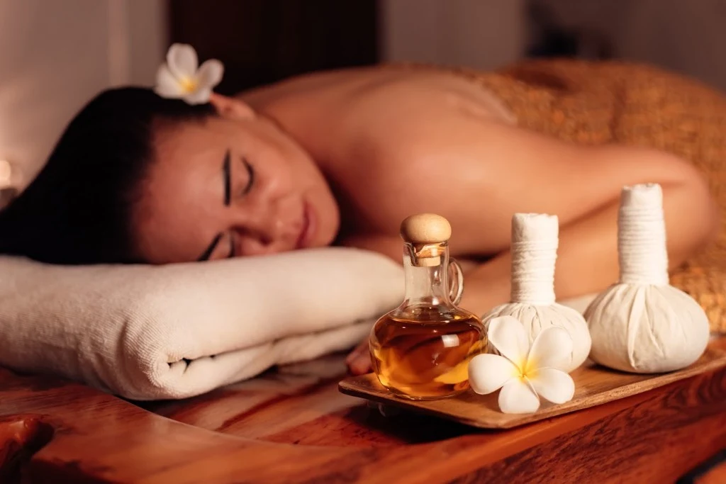 Relaxing massage with herbal pouches and oil